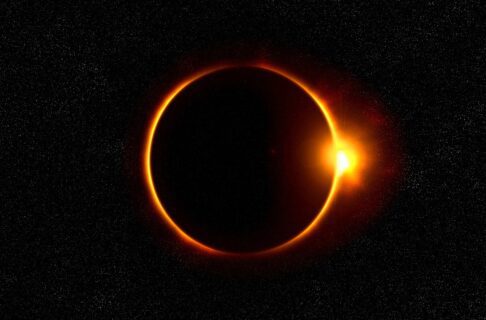 Photo of the "ring of fire" created during a full solar eclipse, with the Moon framed by a thin circle of light as it crosses in front of the Sun.