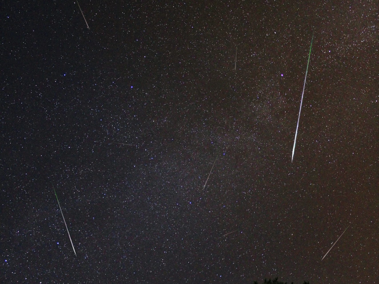 Shooting stars streaking across a clear night sky.