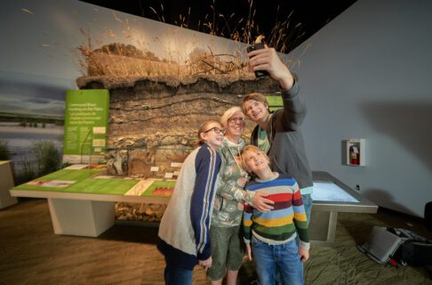 Family taking selfie in front of exhibit