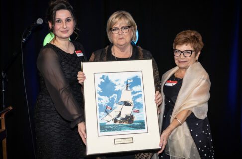 2023 Honouree Barb Gamey being presented with a picture of the Nonsuch by Manitoba Museum CEO Dorota Blumczyńska and Board of Governors chair, Brigette Sandron.