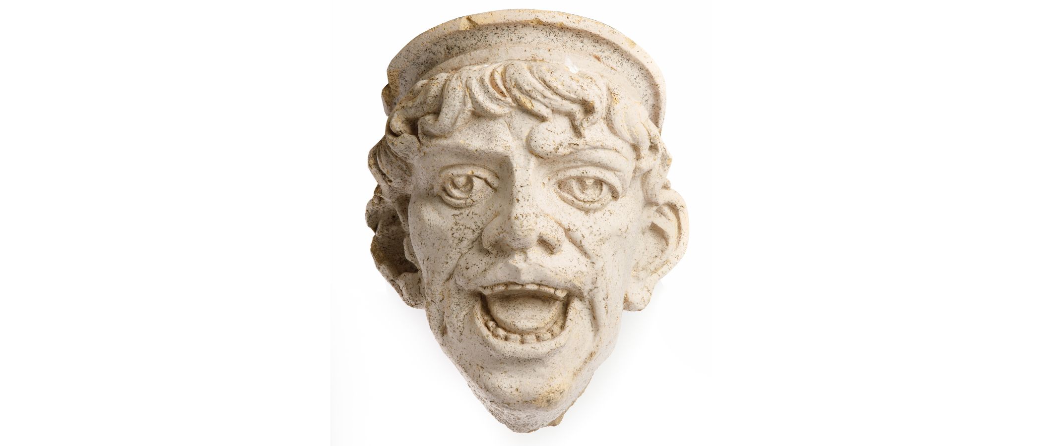 A light-coloured terra cotta head with an open mouth. The figure has shorter wavy hair and is wearing a hat with a small round brim.