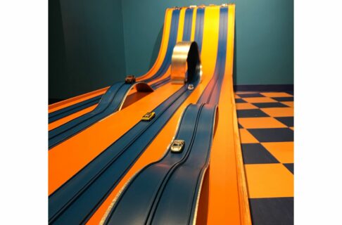 View looking up a matchbox car gravity racetrack. Four different lanes have differing obstacles and dimensions including hills and loops.