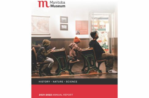 Report cover: A photo of an adult and two children sitting in a row of desks in the schoolhouse within the Prairies Gallery, engaging with the materials. Below the photo a black bar contains the word, “History - Nature – Science,” and on a red bar along the bottom text reads “2021-22 Annual Report”. The Manitoba Museum logo is in the upper left corner.