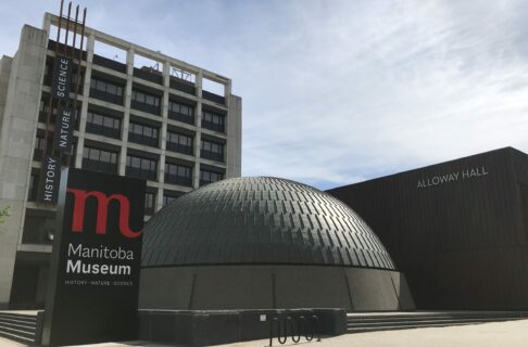 Exterior of the Manitoba Museum, with the Museum, Museum sign, and Planetarium dome in view.