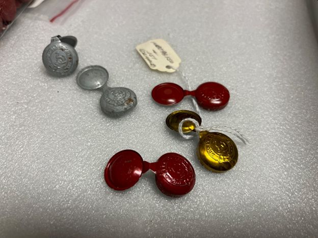 Grey (zinc) seals alongside red and gold examples.