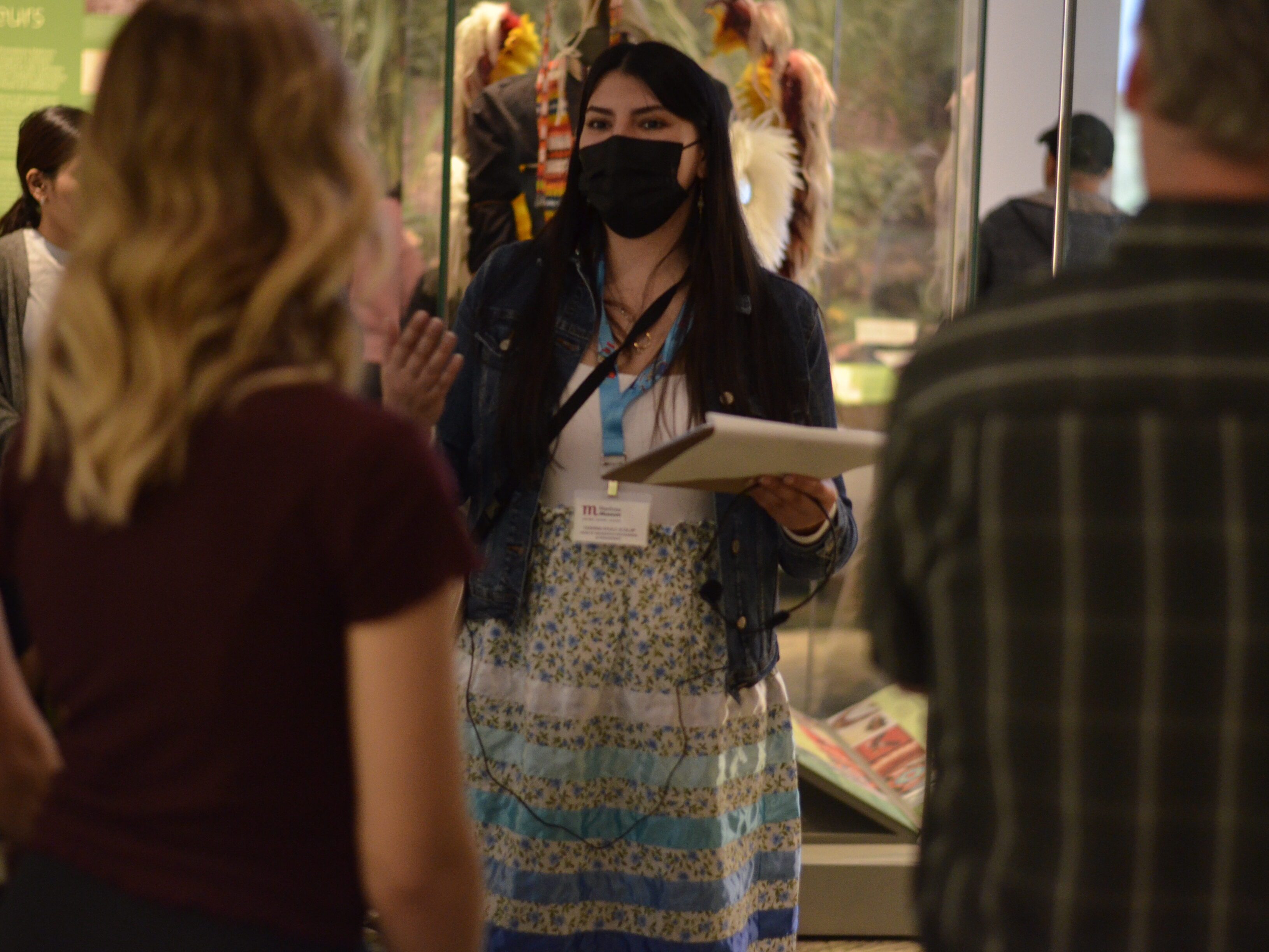 Museum staff member conducting a tour for visitors in the Prairies Gallery.