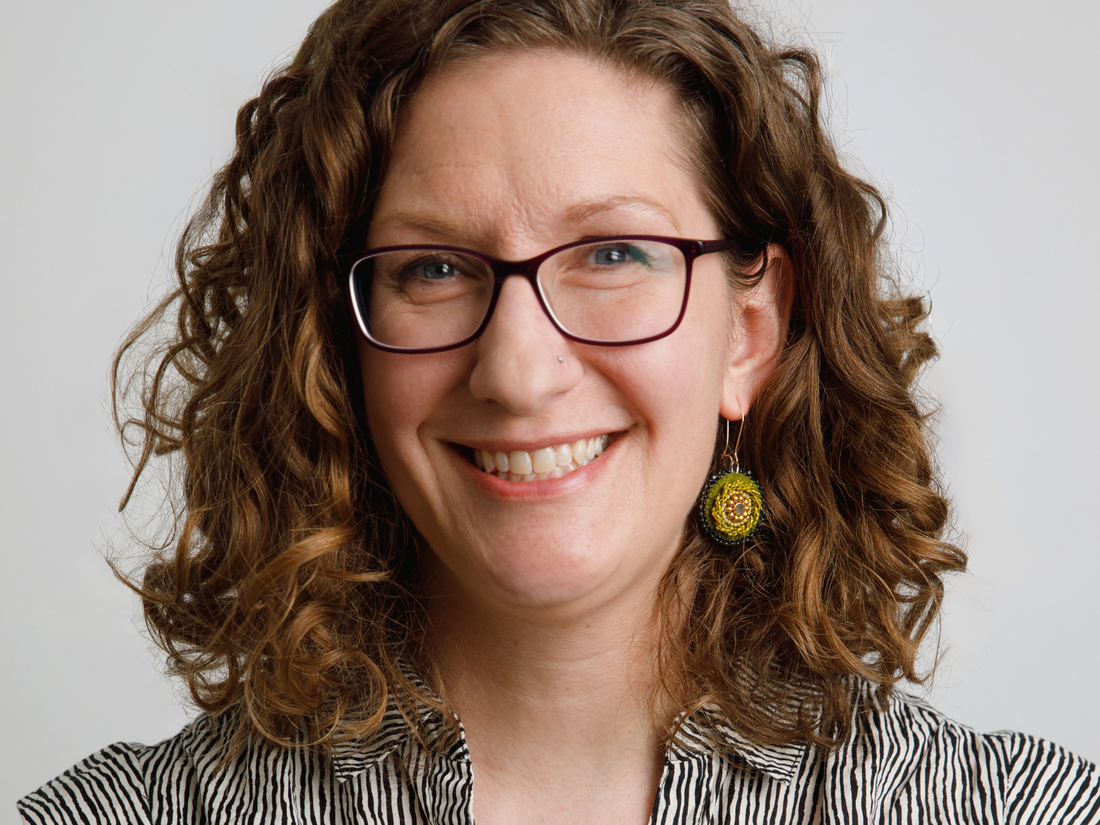 Formal headshot of Dr. Amelia Fay smiling at the camera.