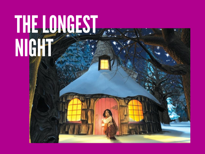 A picture of a young girl puppet holds a lantern a shies away from an unknown threat in front of a wooden cabin, deep in the snowy forest on a fuchsia background. Text reads, "The Longest Night".