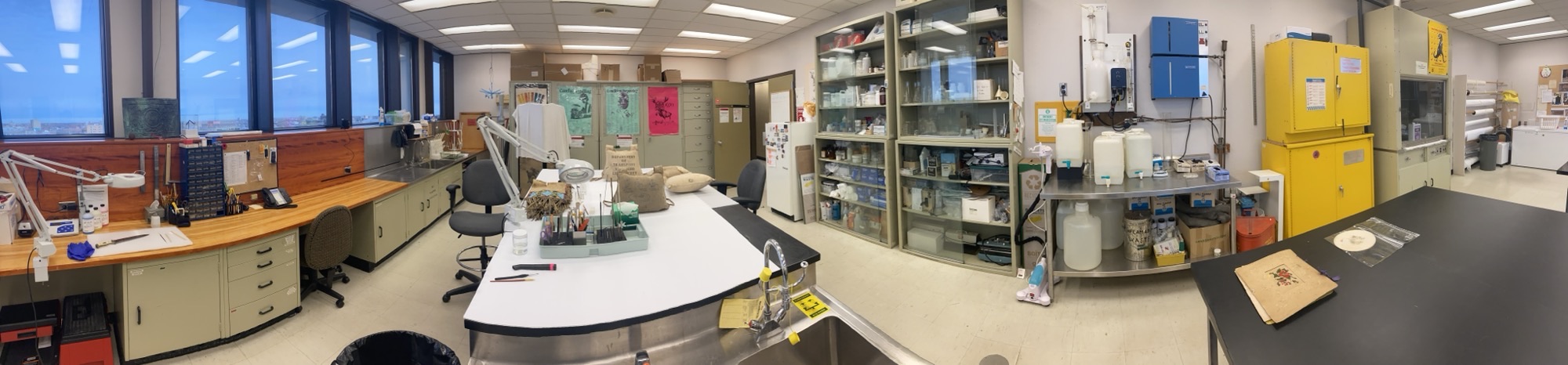 Panoramic photograph of the conservation lab with work stations and storage shelves.