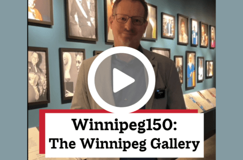A screenshot of a video, an individual standing in front of a wall of portraits in the Winnipeg Gallery. There's a play button over the screenshot and overlaid text reads, "Winnipeg150: The Winnipeg Gallery".