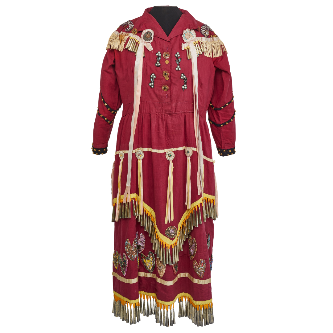 A jingle dress - a red dress with jingles attached along the shoulders and lower hems,