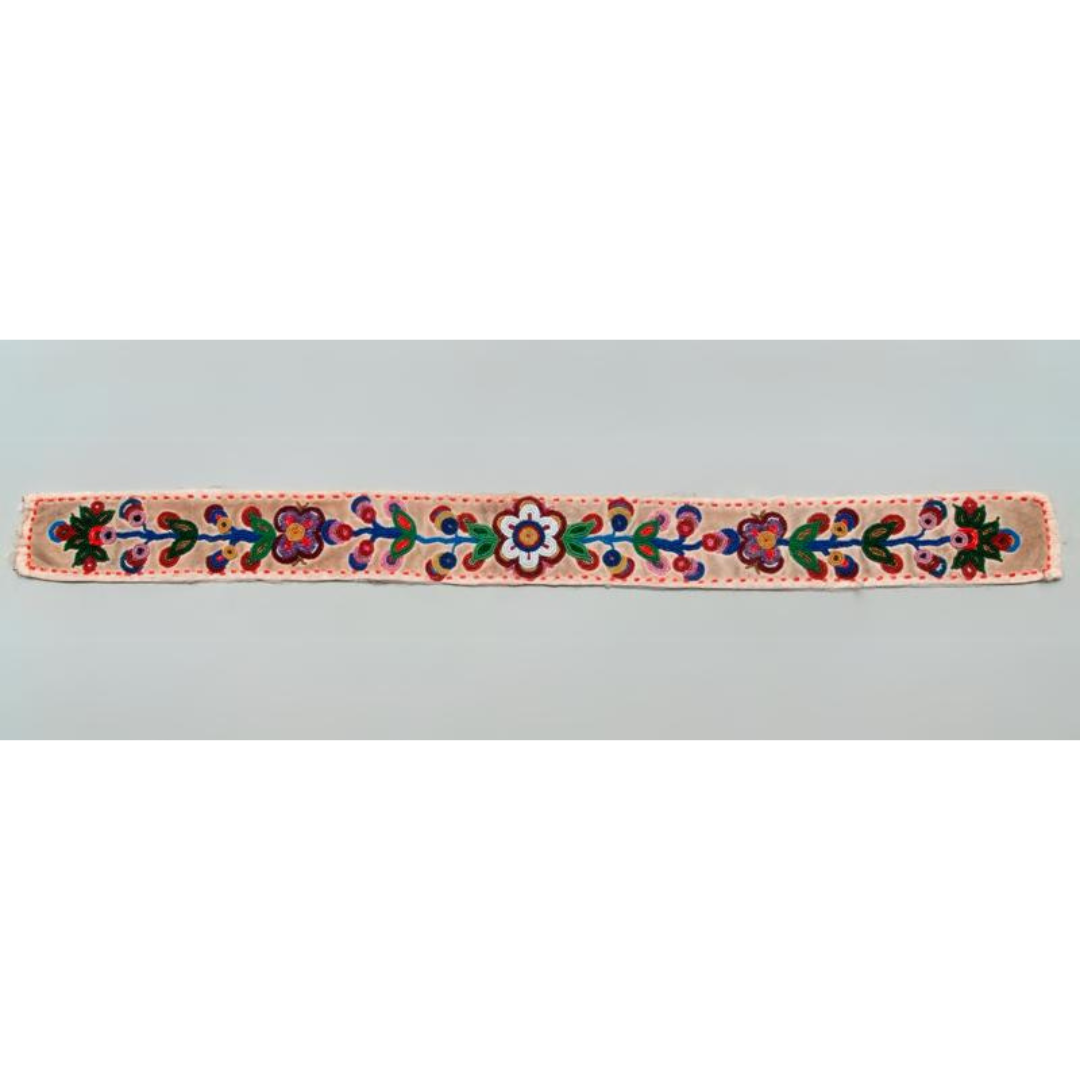 An intricately beaded belt with a light coloured base and colourful beaded flowers.