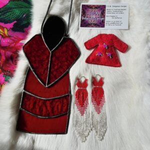 Beaded earrings, stained glass, and pins in a red dress design with a J.D.M Indigenous Designs business card..