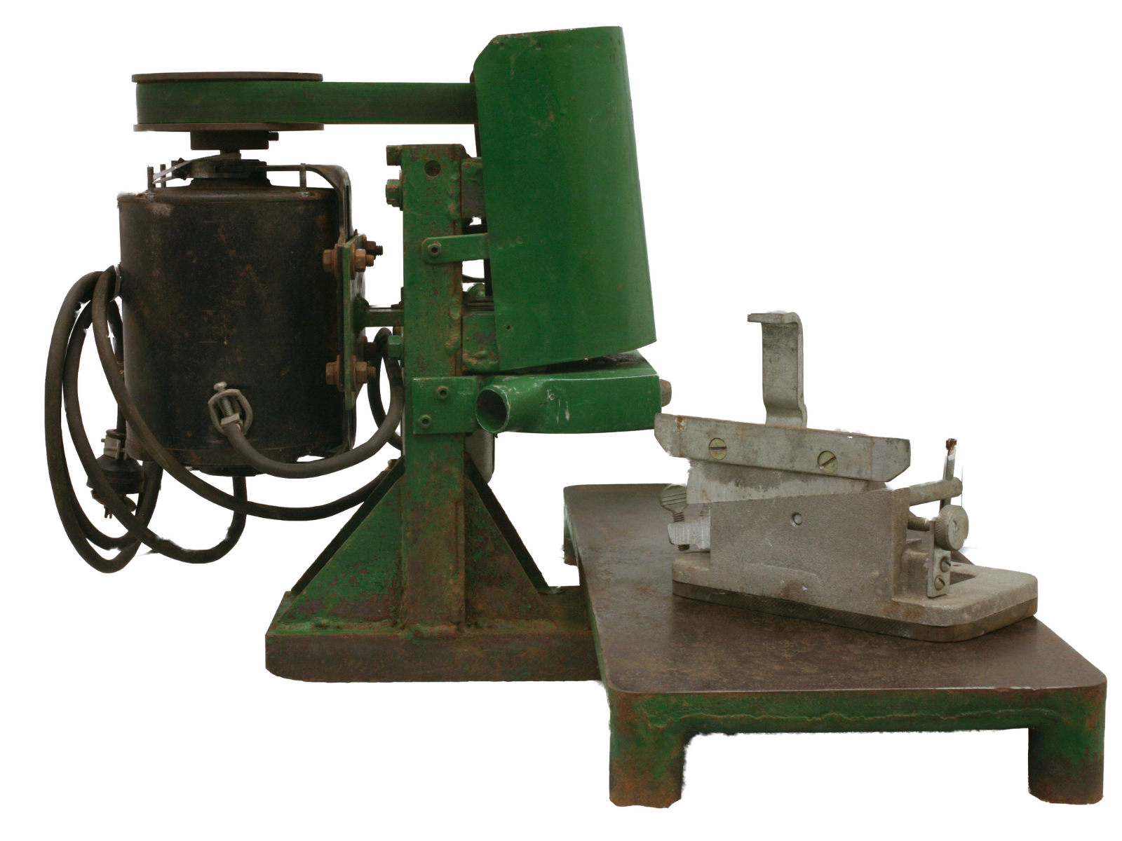 A metal skate sharpener with worn green paint and rust spots.