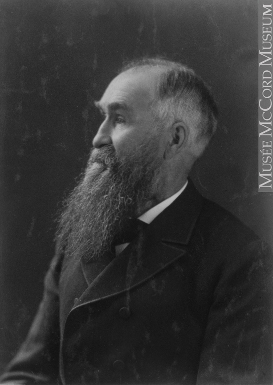 Formal photograph of an older man with a long beard looking off to the side.