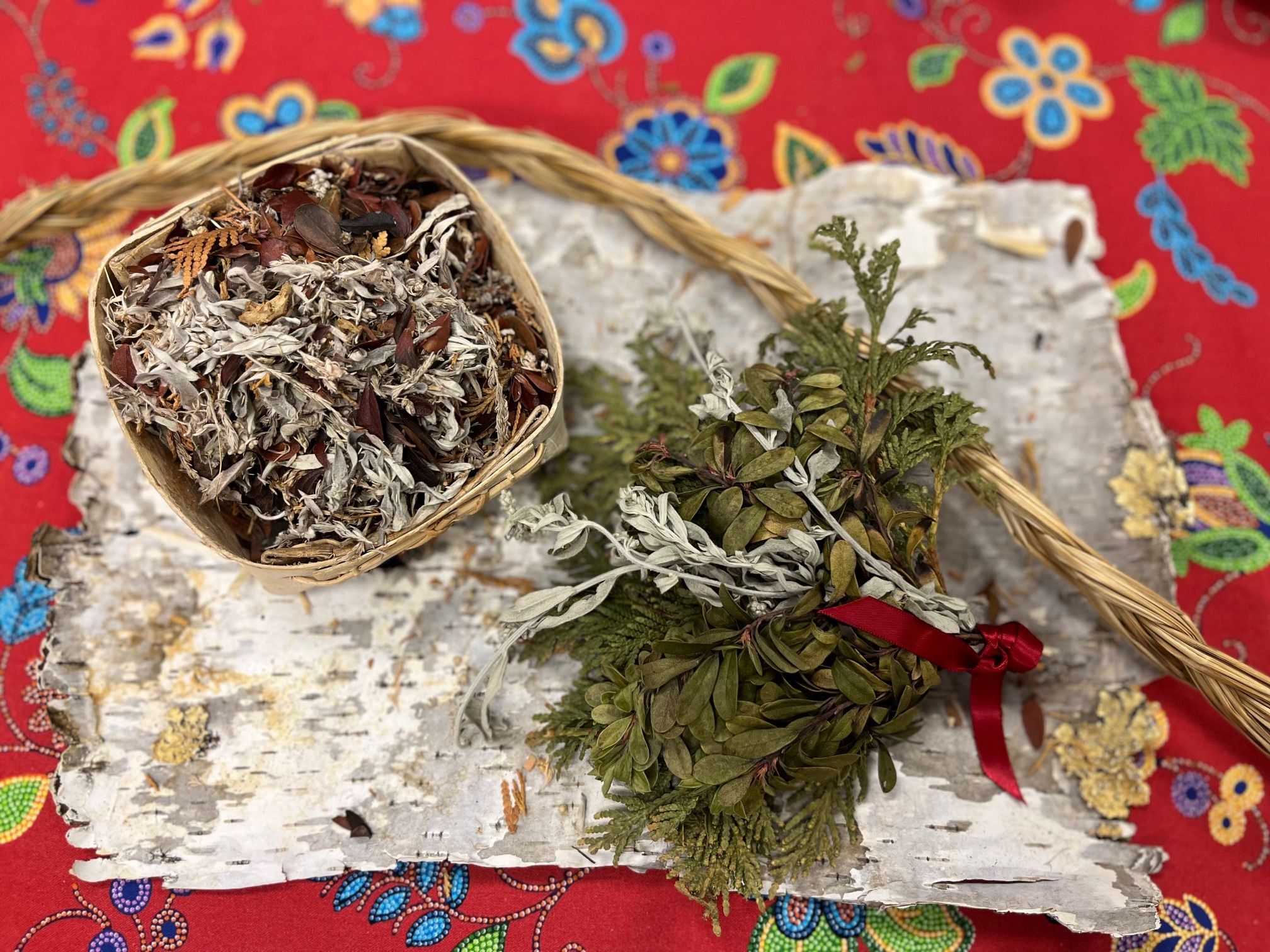 Traditional Indigenous medicines laid out on a patterned cloth.