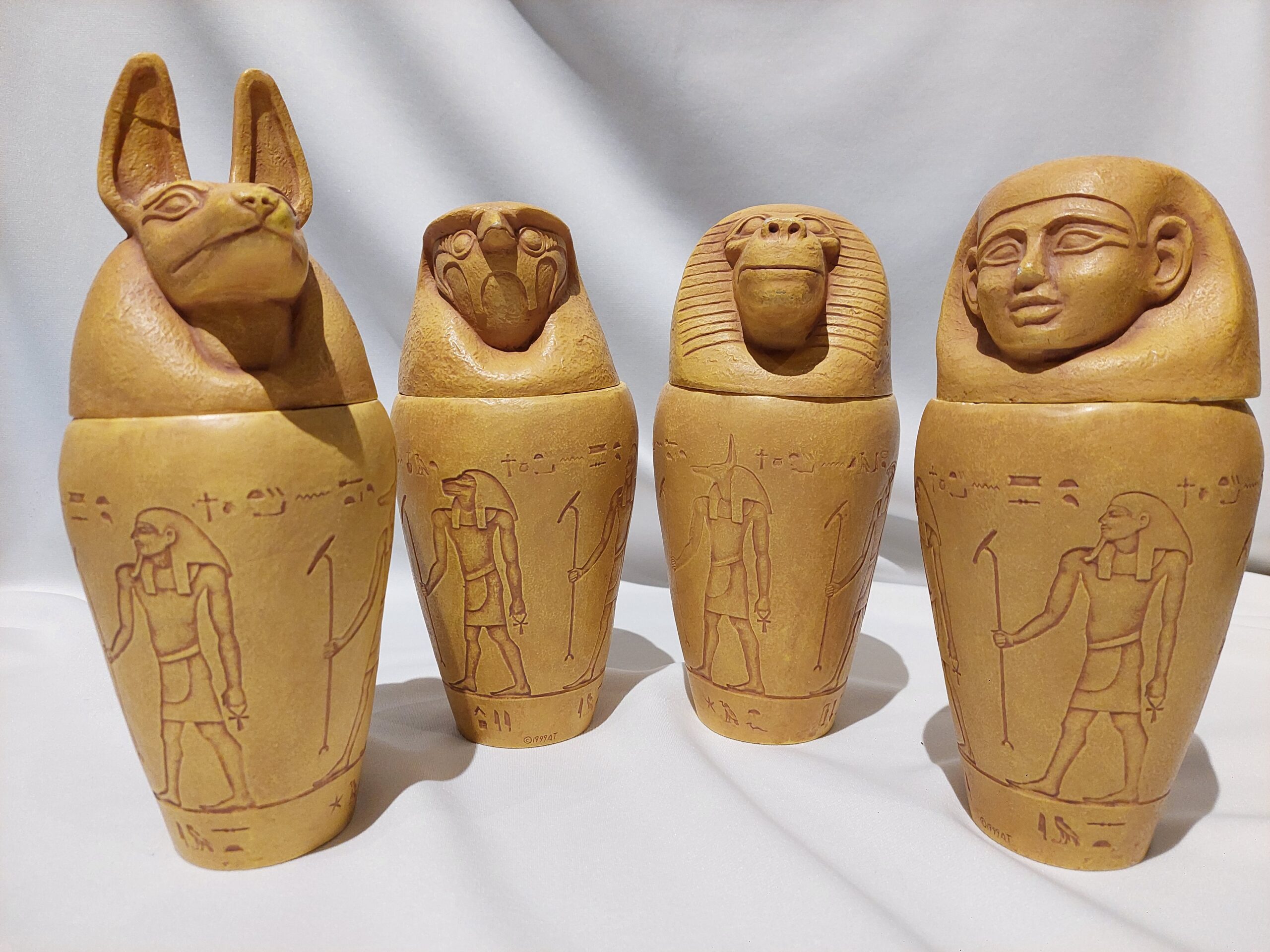 Four jars used in the Egyptian mummification process. Each jar has a lid with a different animal or figure head.