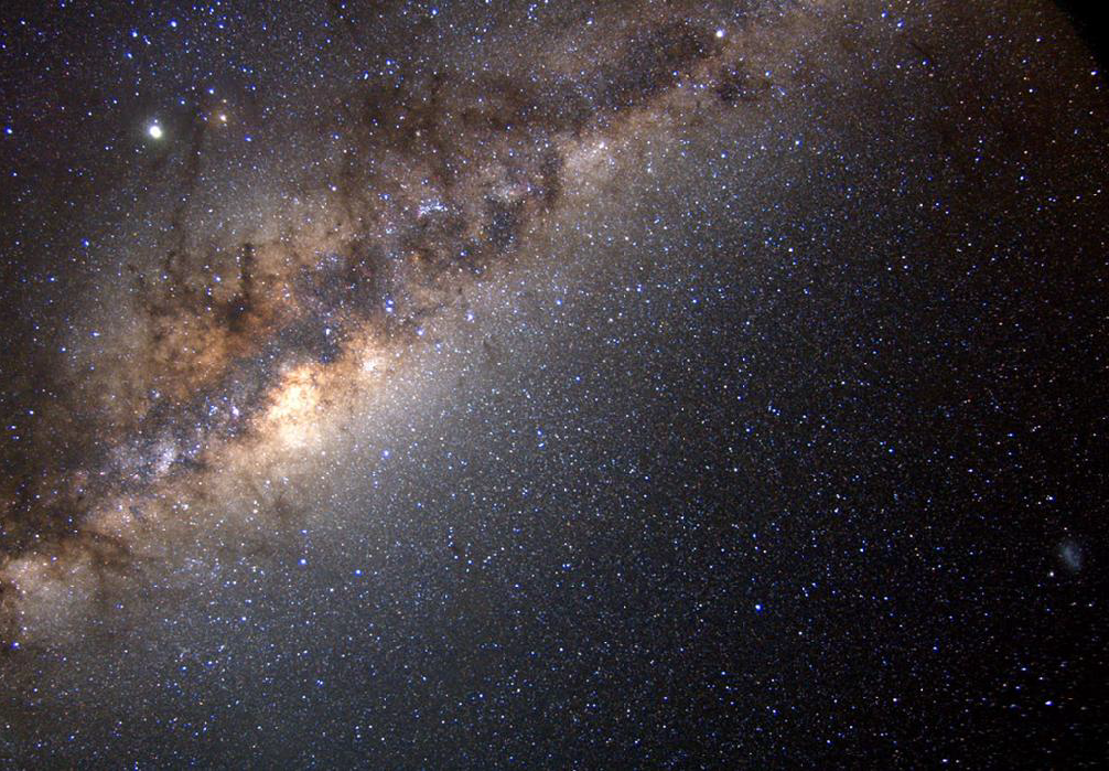 Photograph of the Milky Way and hundreds of stars in the sky.