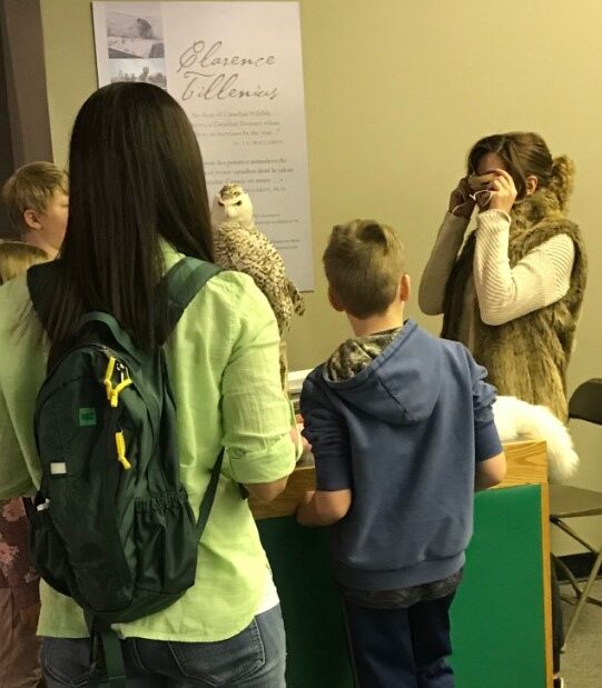 A Museum volunteer demonstrating the use of an artifact at a programming pop-up in the Arctic & Subarctic Gallery.