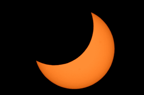 The Sun shown during a partial Solar Eclipse, half obstructed by the Moon.