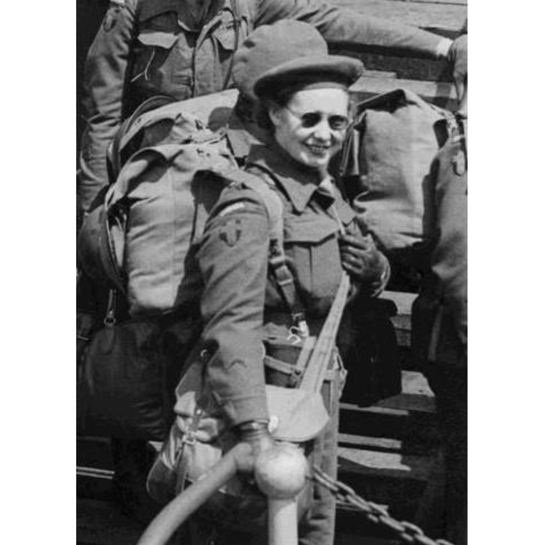 A black and white photograph of Mary Attree in military uniform and sunglasses, smiling towards the camera.