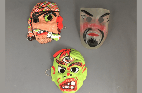 Three vintage Halloween masks for children of characters like a pirate, or a monster.