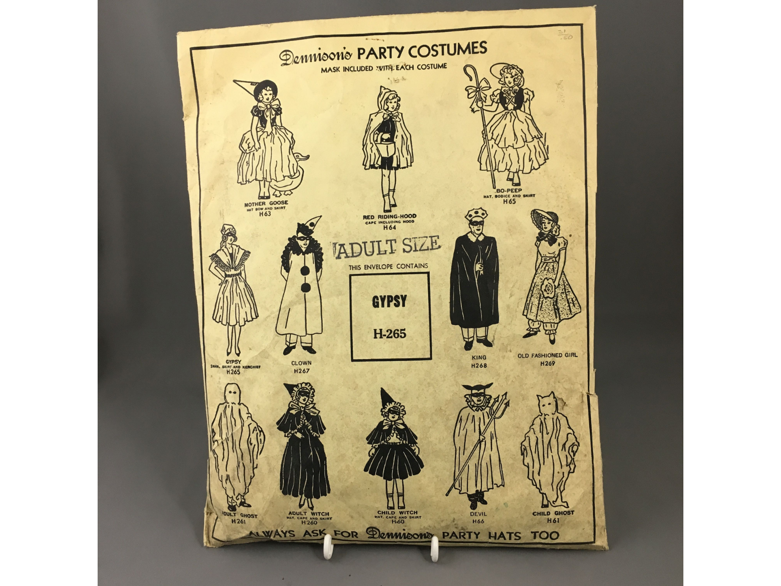 A paper product bag for an adult size "Gypsy" party costume. The front of the bag shows a series of costume types that can be purchased including a clown, king, witch, and ghost.