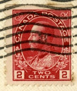 Red two cent Canadian stamp featuring image of King George.