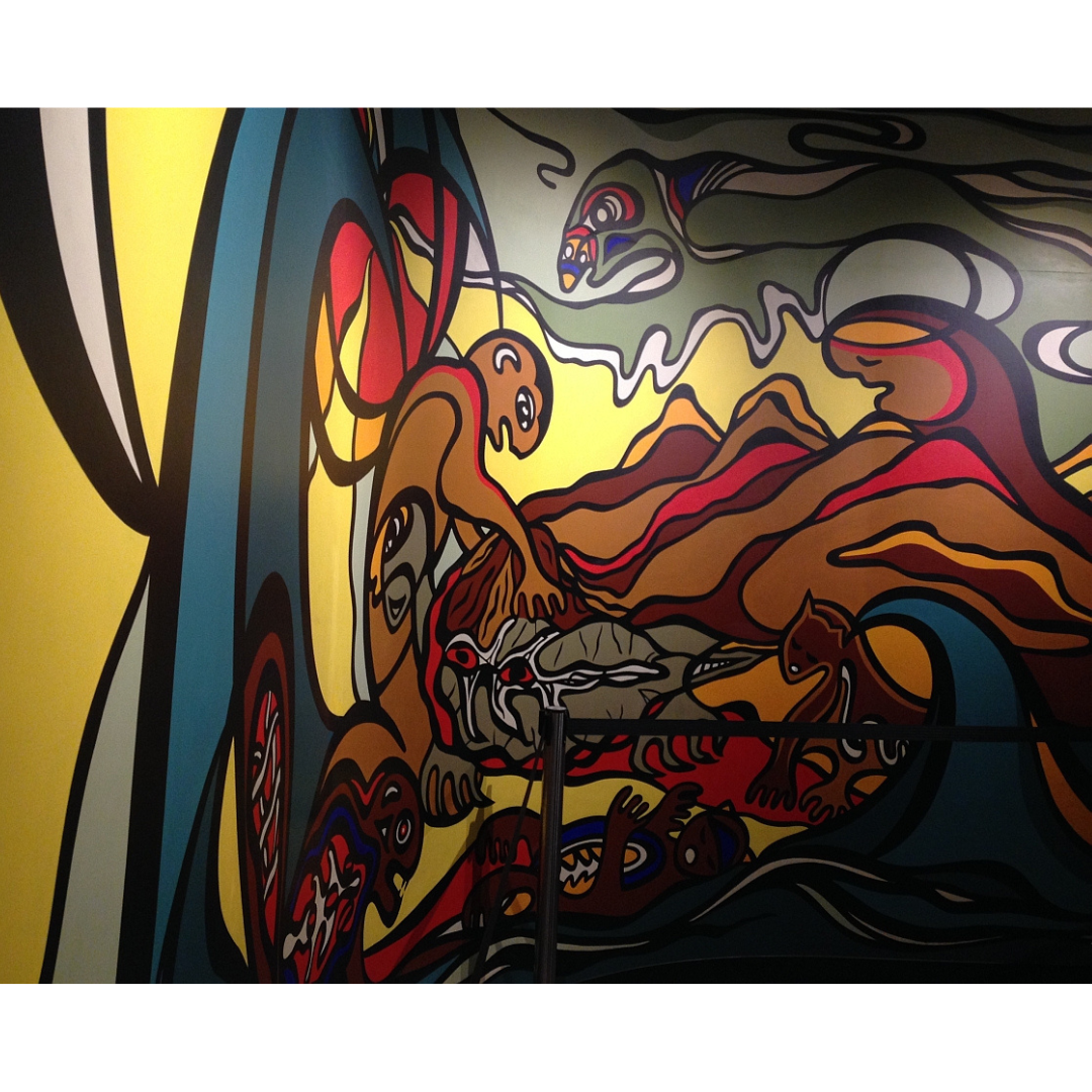 The retouched "Creation of the World" mural, in bright colours on a concave curved wall.