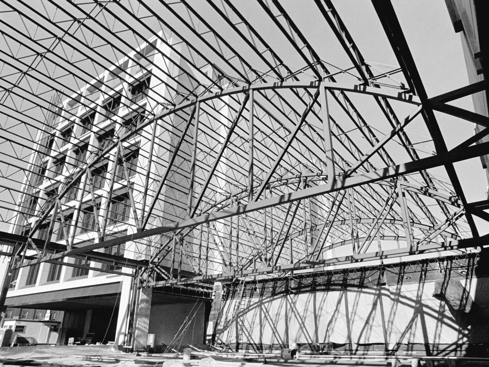 A black and white photograph of the frame of what will become Alloway Hall under construction.