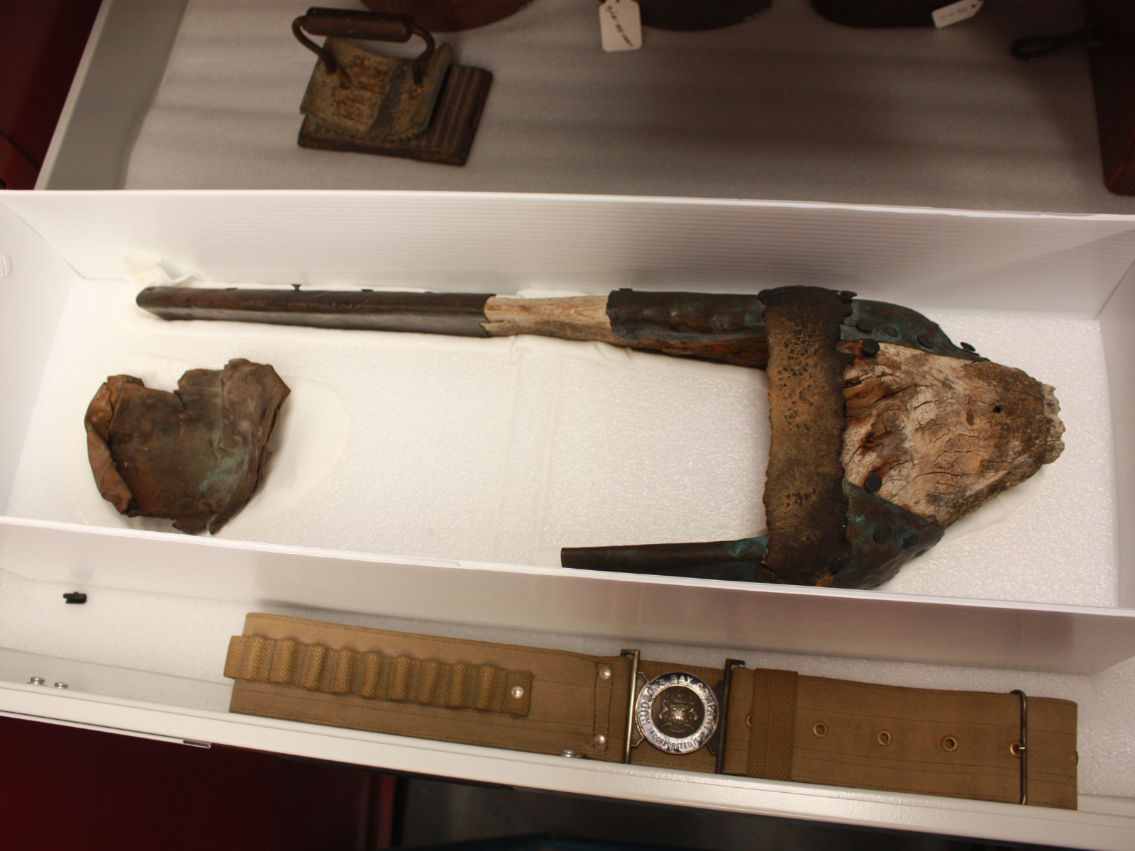 A view of the artifact inside the storage box, a prosthetic peg leg.