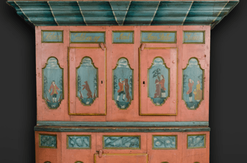 Close up on a cabinet with five panels showing part of a story.