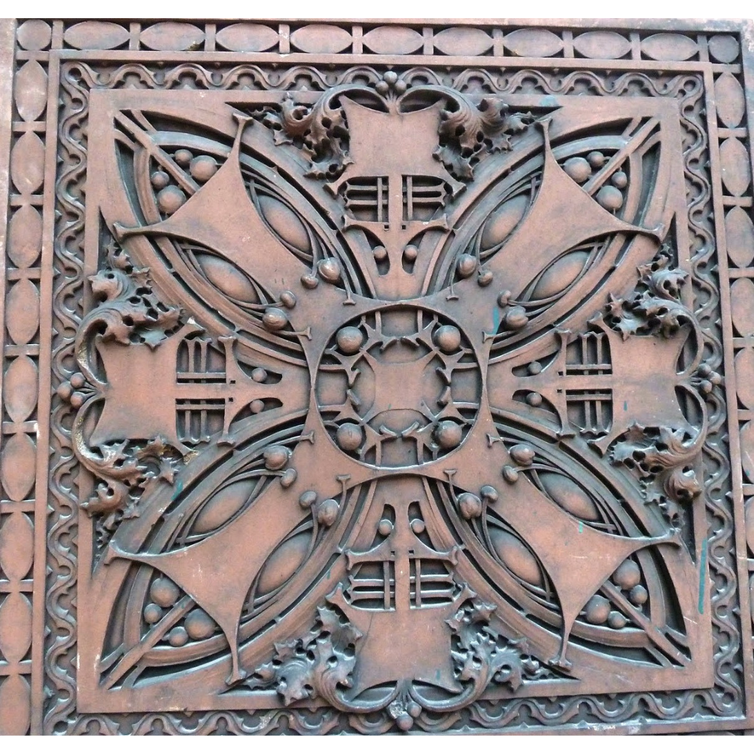 A four-petaled decorative panel in a copper-colour.