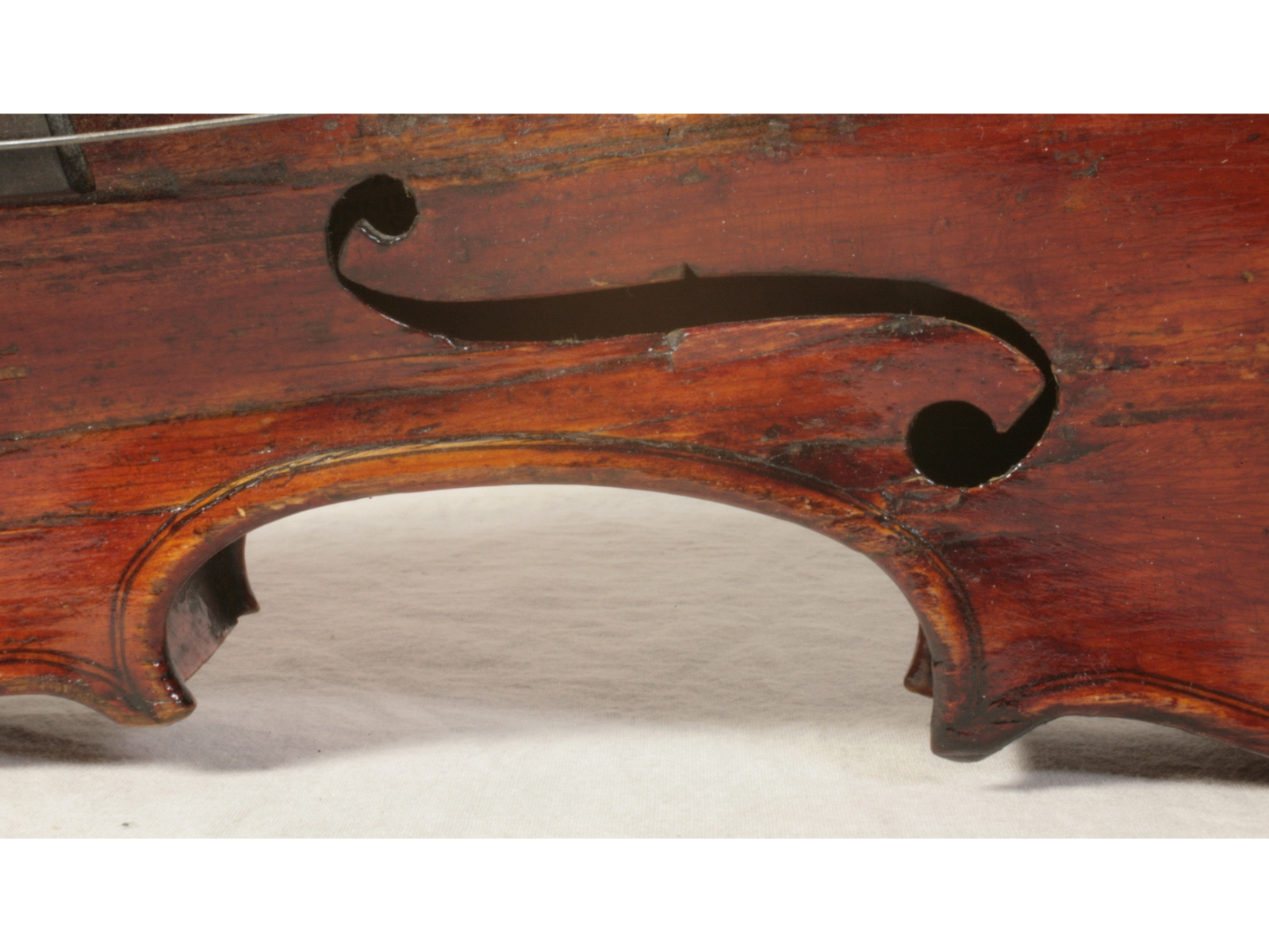 Close-up on one of the sound holes of a violin.