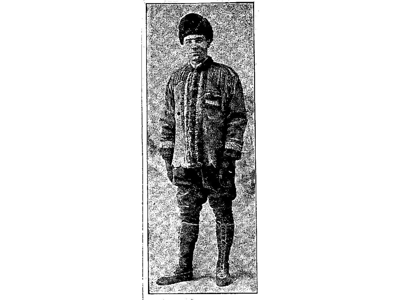 A newspaper clipping photograph of a man in a brimless hat, jacket, and knee high boots.