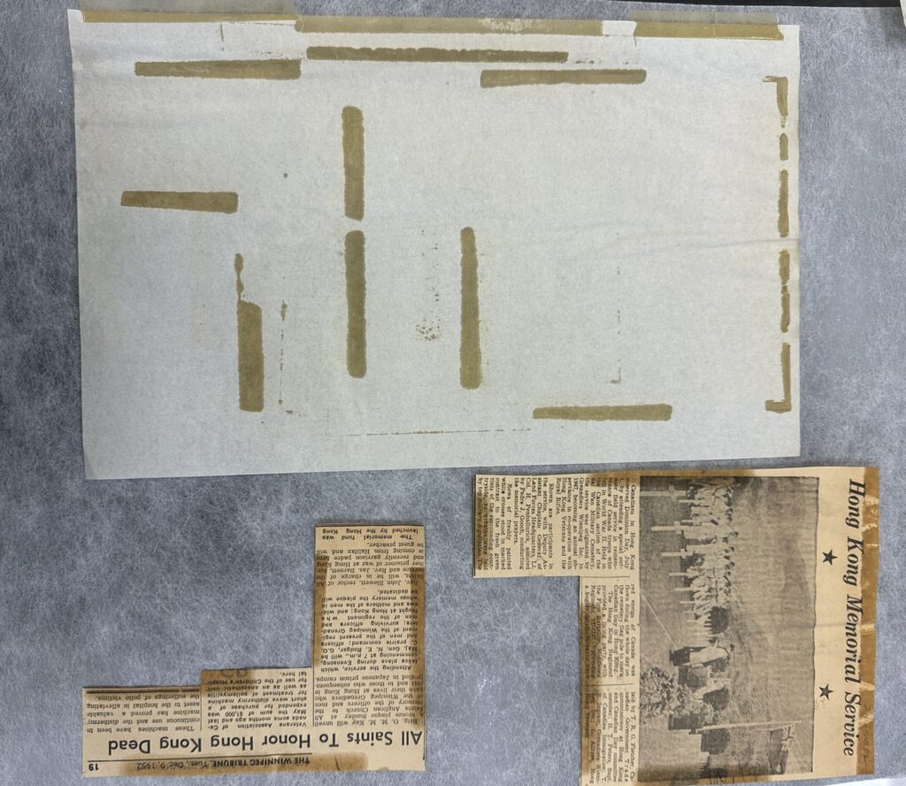 One page with multiple pieces of tape and removed pieces of newspaper.