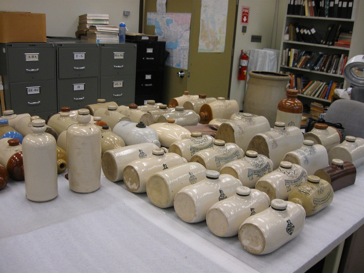 A few dozen Medalta pottery footwarmers - tube-shaped containers with blunt ends and a cork like stopper in the middle.