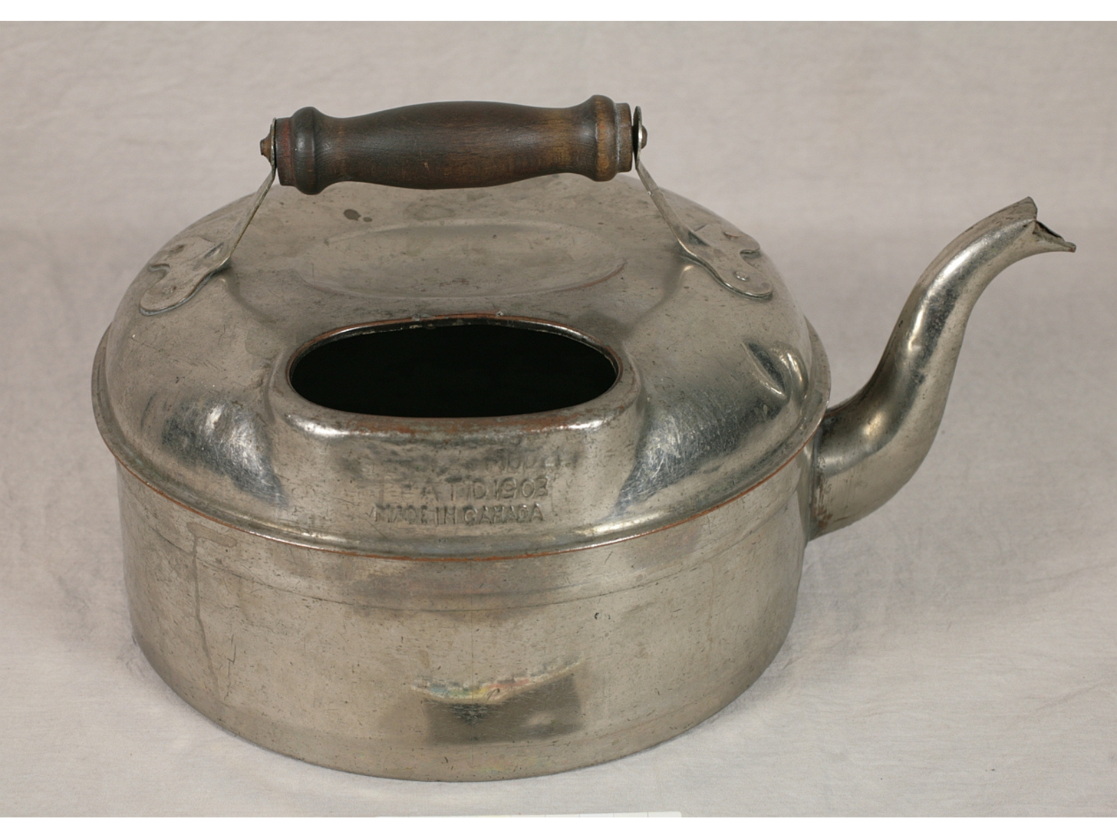 A large shiny silver kettle.