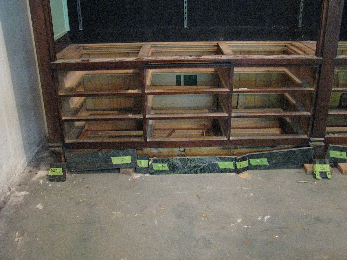 The drawer cavities of a large display case with the drawers removed..