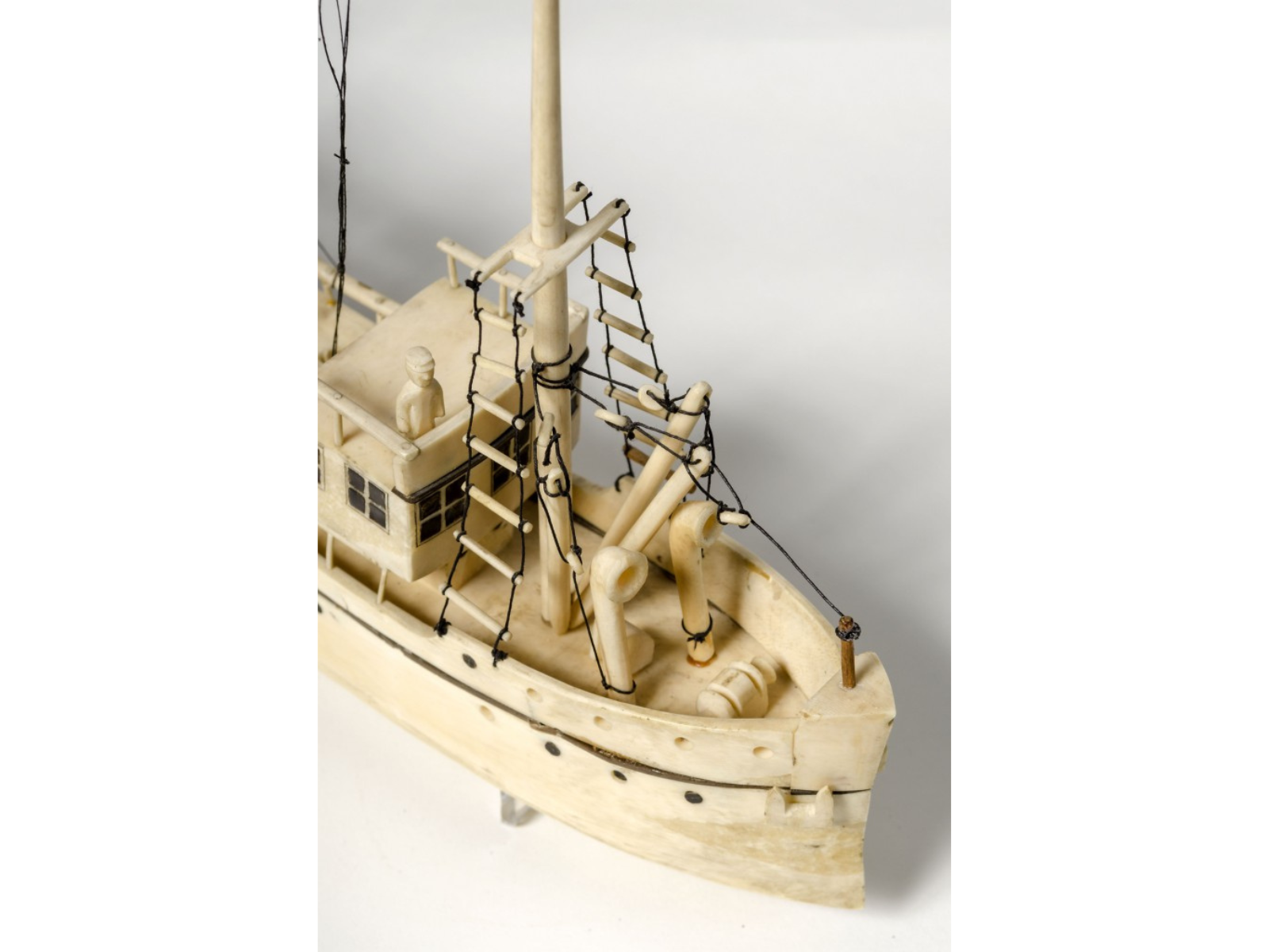 Close-up on a small ivory model of a ship.