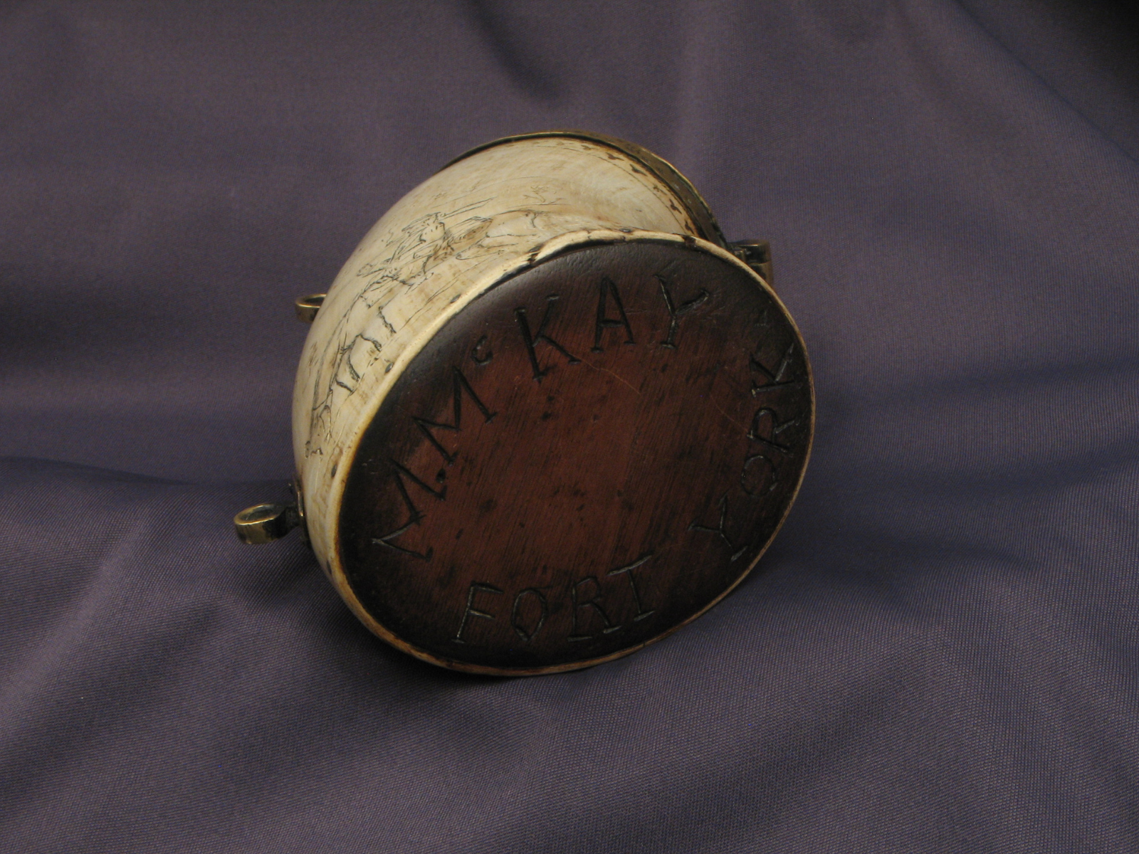 The base of the horn cannister with "M. McKay Fort York" carved into the base.