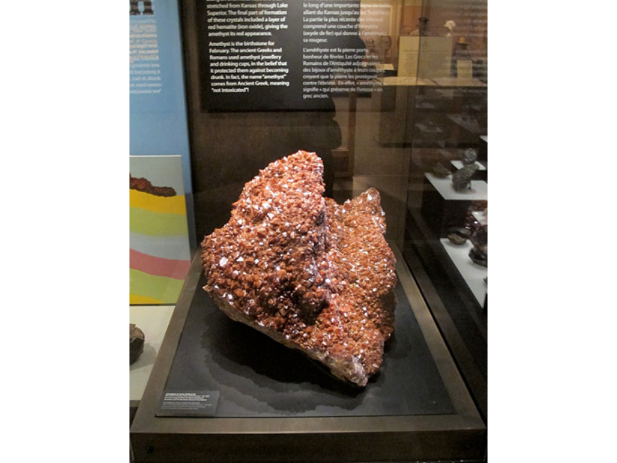 A large pinkish amethyst in a display case.