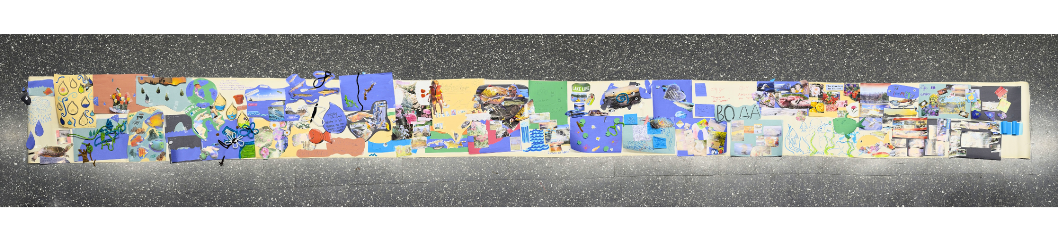 A panoramic photograph of a large hand-made collage featuring youth participants' connections to water. The art piece includes drawings, magazine cut-outs, pipe cleaners, and more.