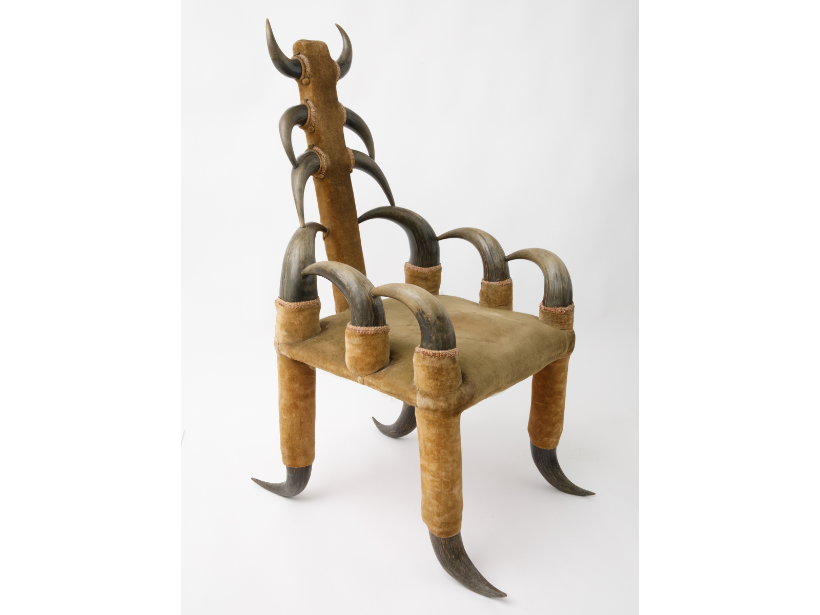 An ornate armchair with the back, legs, and arms made of interconnected bison horns.