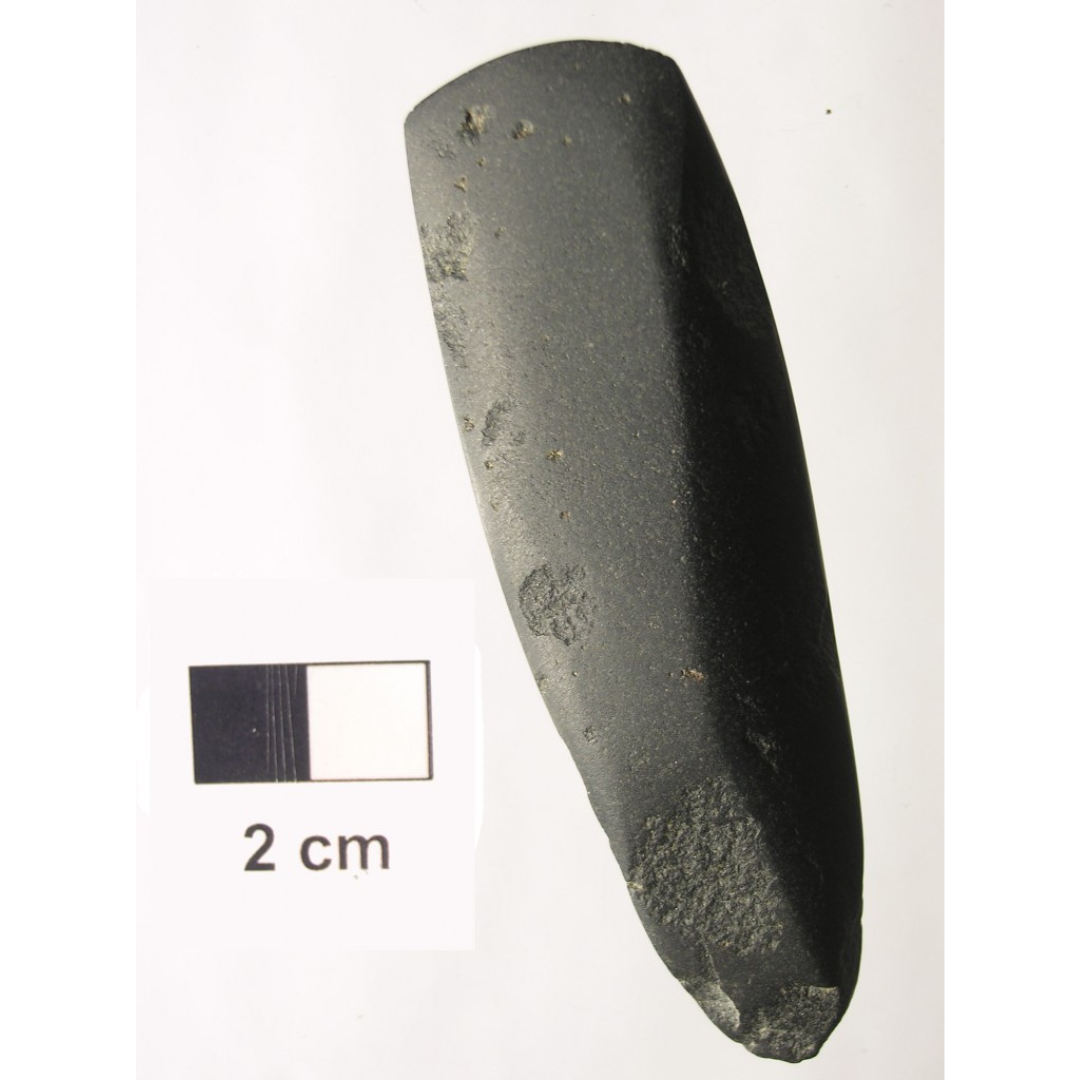 An oblong carved stone tool with sharpened edges.