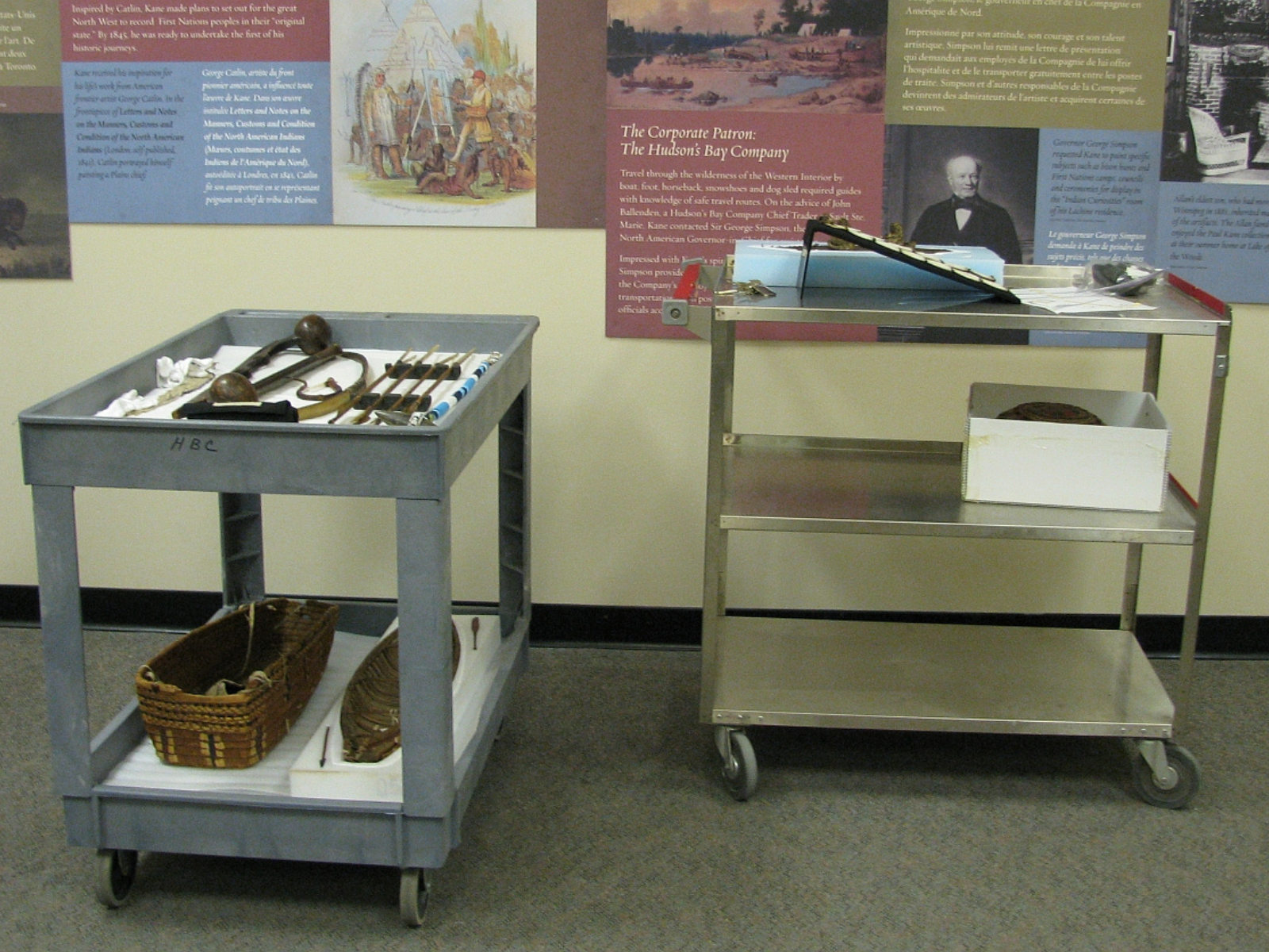 Two rolling carts with artifacts and objects laid out on their shelves.