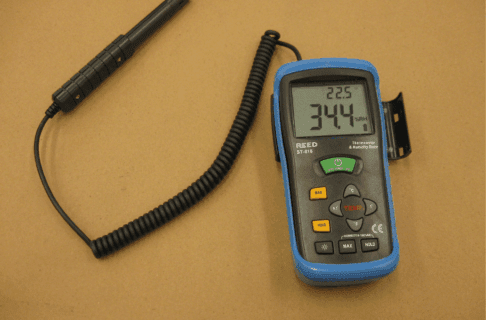 A thermohygrometer attached to a sensor on a coil.