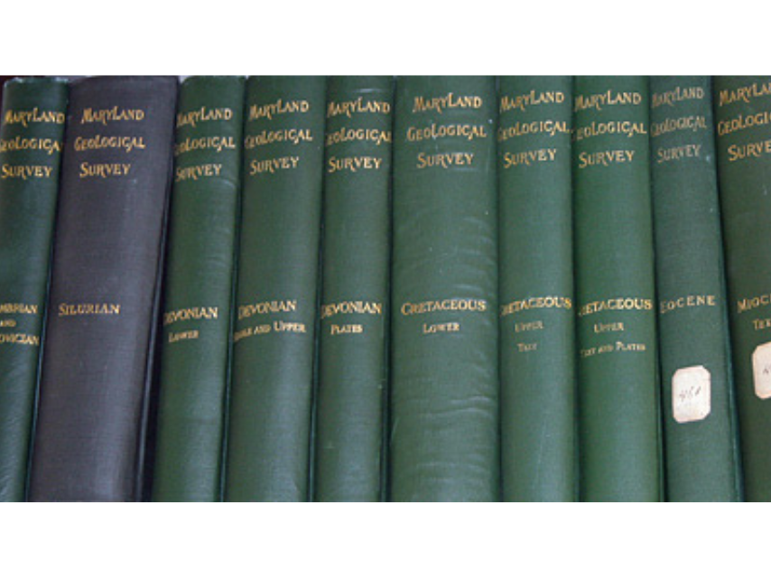 Close-up on the spine of a row of green and navy books in the series of the Maryland Geological Society.