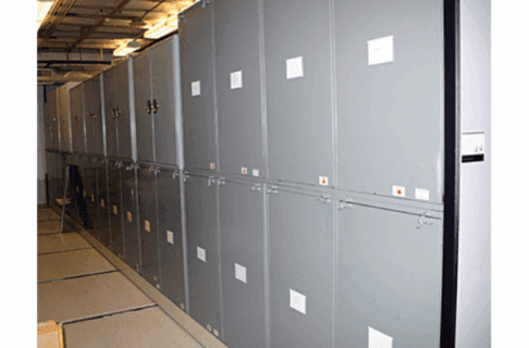 Looking down a row of metal cabinets in Museum collections storage.