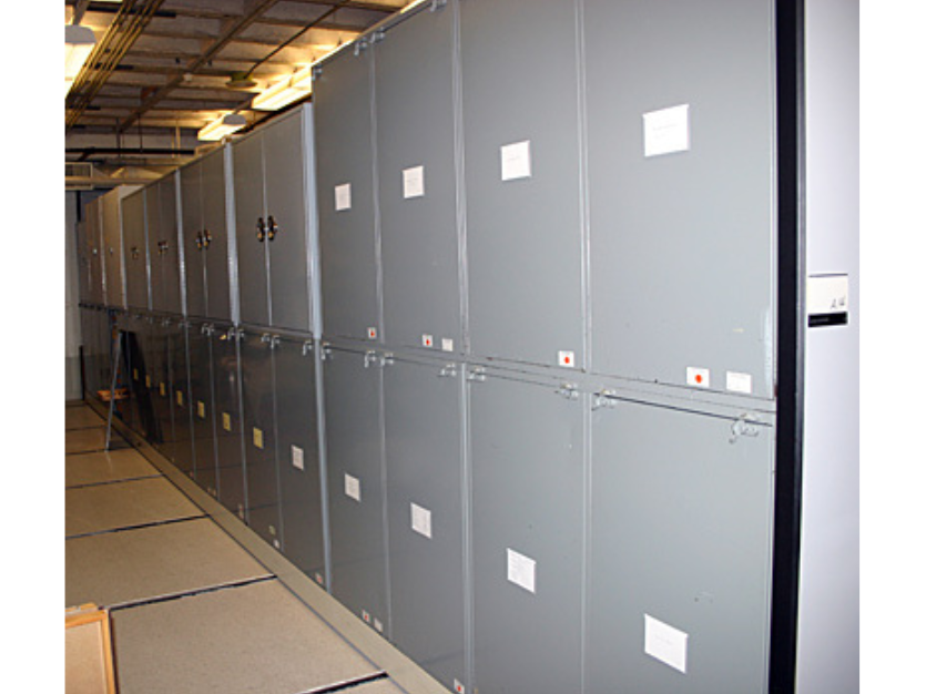 Looking down a row of metal cabinets in Museum collections storage.